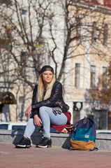 Lady girl happy smiles, sits skateboard.