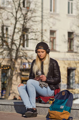 Lady girl happy smiles, sits skateboard.