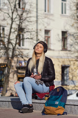 Lady girl happy smiles, sits skateboard.