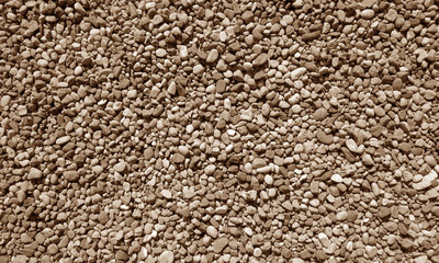 Pile of small gravel stones in brown tone.
