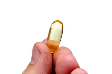 Vitamin e omega 3 fish oil yellow pills in a hand vitamins sport nutrition healthy on the white...