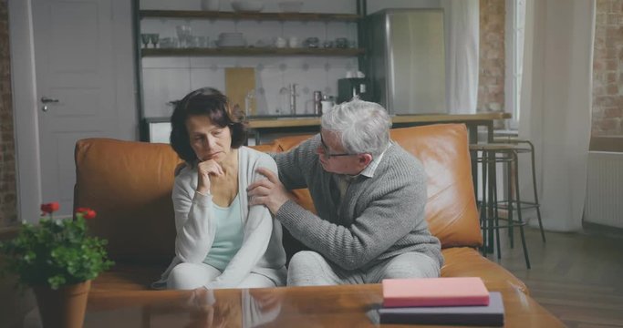 Senior man tries to comfort his disappointed wife