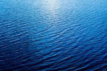 Fototapeta premium aerial view to blue water with reflections