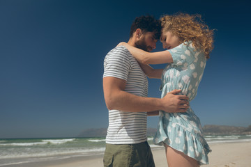 Young couple standing at beach on a sunny day