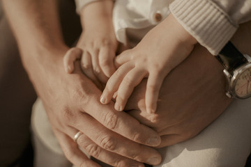 hands of woman with hands of child