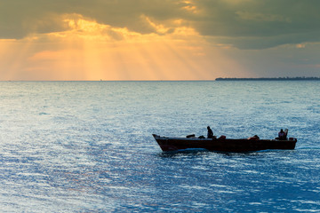 evening fishing boat activity on the ocean near to the harbour
