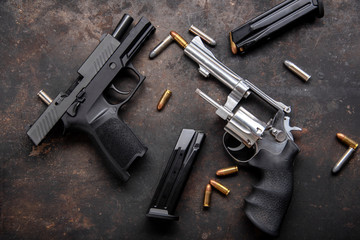 Gun with ammunition on dark background. 