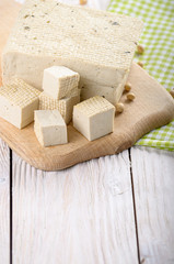 Soy Bean curd tofu on cutting board Non-dairy alternative substitute for cheese