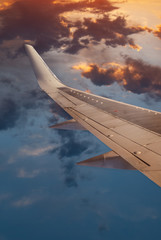 The wing of the aircraft against the dramatic sky