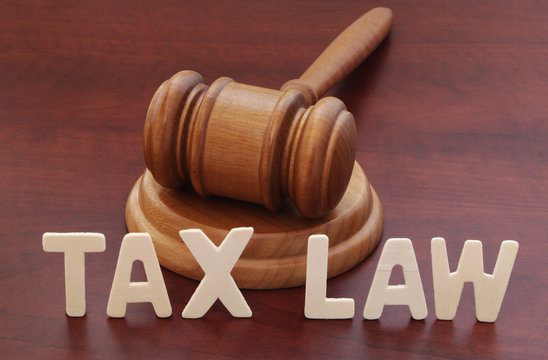 Tax laws concept. Words tax law and wooden judge gavel on table