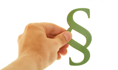 Hand holds green paragraph symbol