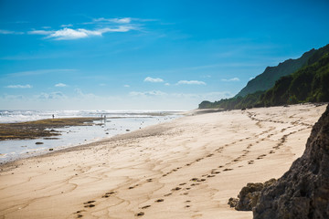 Tropical beach with white sand, blue ocean and waves