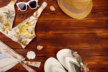 Vacation travel equipment Straw hat, sunglasses And marine objects, shells, on wooden floor - Image