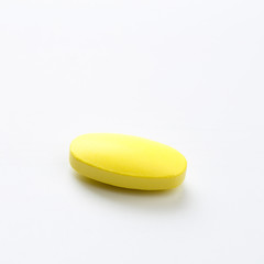 yellow pill  on  white background .