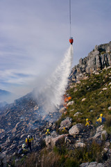 Fototapeta na wymiar Wildland firefighters on mountain with water bombing