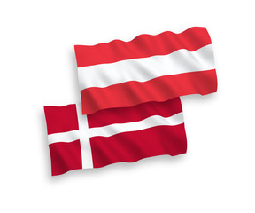 National vector fabric wave flags of Austria and Denmark isolated on white background. 1 to 2 proportion.
