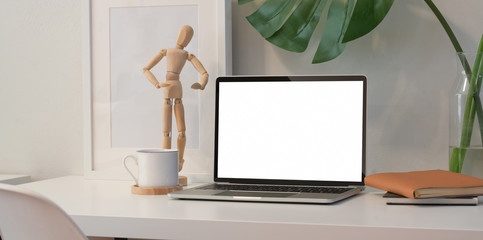 Laptop on white desk in minimal office room