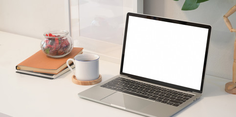 Fototapeta premium Laptop on white wooden desk in creative studio