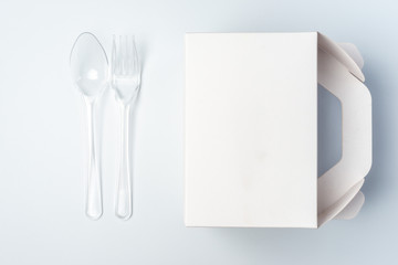 White Cardboard Fast Food Box, Packaging For Lunch and plastic fork and spoon. On White Background Isolated. Ready For Your business design