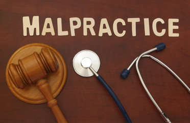 Gavel and stethoscope on wooden background, malpractice concept