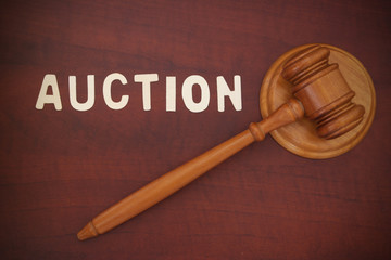 Wooden gavel on table with word auction, sale and buy concept