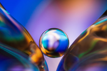 Small glass ball in abstract macro composition.