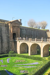Tourists at the main entrance of the Montjuic Castle on the mountain of Montjuic, in the city of Barcelona. Spain.