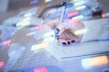 Multi exposure of woman's writing hand on background with data technology hud. Concept of...