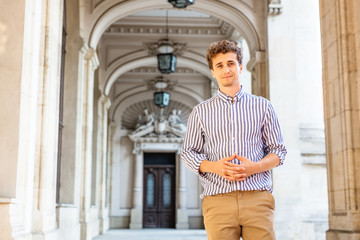 young stylish man standing on the hall
