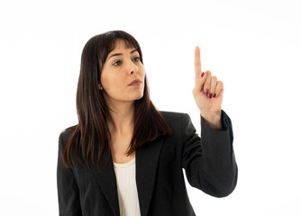 Portrait of a young beautiful and confident business woman pointing. Isolated on white background.