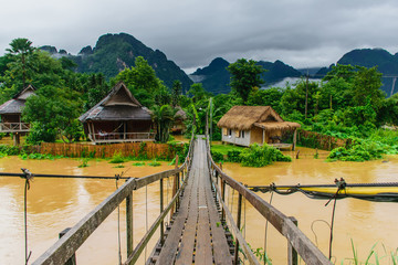 Fototapeta na wymiar A wooden bridge crossing the Nam Song river Vang Vieng-Vientiane province-Laos.