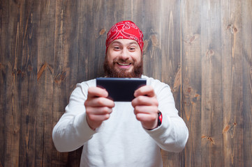 bearded man  holding smart phone