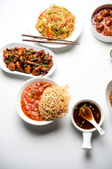 Assorted Indo chinese dishes in group includes Schezwan/Szechuan hakka noodles, veg fried rice, veg manchurian, american chop suey, chilli paneer, crispy vegetable and vegetable soup