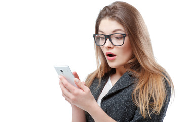 Surprised young woman in glasses using smart phone.