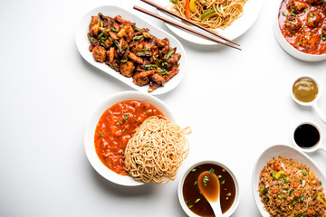 Assorted Indo chinese dishes in group includes Schezwan/Szechuan hakka noodles, veg fried rice, veg manchurian, american chop suey, chilli paneer, crispy vegetable and vegetable soup