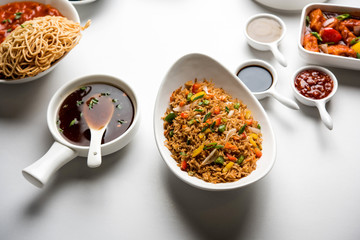 Assorted Indo chinese dishes in group includes Schezwan/Szechuan hakka noodles, veg fried rice, veg manchurian, american chop suey, chilli paneer, crispy vegetable and vegetable soup