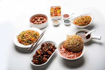 Assorted Indo chinese dishes in group includes Schezwan/Szechuan hakka noodles, veg fried rice, veg manchurian, american chop suey, chilli paneer, crispy vegetable and vegetable soup