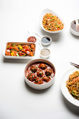 Assorted Indo chinese dishes in group includes Schezwan/Szechuan hakka noodles, veg fried rice, veg manchurian, american chop suey, chilli paneer, crispy vegetable and vegetable soup