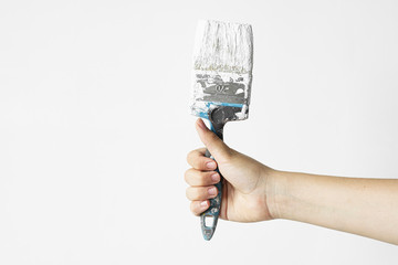 Womans hand holding a paintbrush on a white background