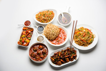 Assorted Indo chinese dishes in group includes Schezwan/Szechuan hakka noodles, veg fried rice, veg manchurian, american chop suey, chilli paneer, crispy vegetable and vegetable soup