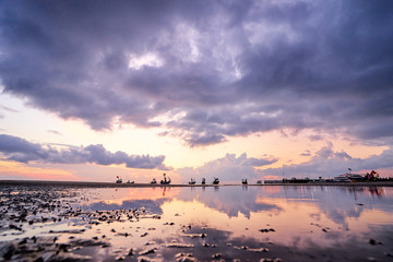 Beautiful tropical sunset. Seascape with purple sky and longtail boats. Samui Island, Thailnd.
