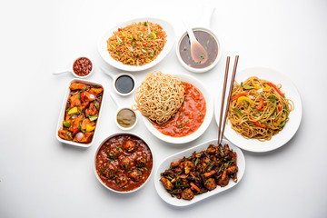 Assorted Indo chinese dishes in group includes Schezwan/Szechuan hakka noodles, veg fried rice, veg manchurian, american chop suey, chilli paneer, crispy vegetable and vegetable soup