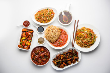 Assorted Indo chinese dishes in group includes Schezwan/Szechuan hakka noodles, veg fried rice, veg manchurian, american chop suey, chilli paneer, crispy vegetable and vegetable soup