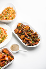 Assorted Indo chinese dishes in group includes Schezwan/Szechuan hakka noodles, veg fried rice, veg manchurian, american chop suey, chilli paneer, crispy vegetable and vegetable soup