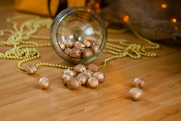 Golden nuts on the huge wineglass. Christmas and New Year