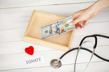 Donations and Charity. Donation Concept. Box of Donations and Heart on the White Background.
