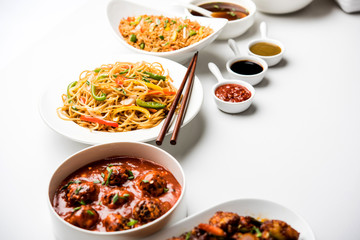 Assorted Indo chinese dishes in group includes Schezwan/Szechuan hakka noodles, veg fried rice, veg manchurian, american chop suey, chilli paneer, crispy vegetable and vegetable soup