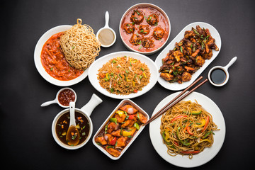 Assorted Indo chinese dishes in group includes Schezwan/Szechuan hakka noodles, veg fried rice, veg manchurian, american chop suey, chilli paneer, crispy vegetable and vegetable soup - obrazy, fototapety, plakaty