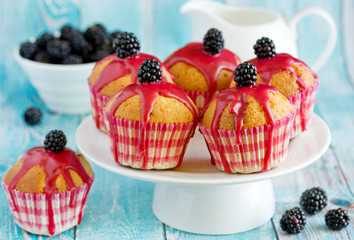 Homemade muffins with blackberry pink frosting