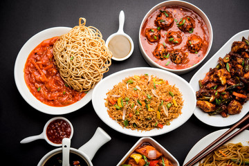 Assorted Indo chinese dishes in group includes Schezwan/Szechuan hakka noodles, veg fried rice, veg manchurian, american chop suey, chilli paneer, crispy vegetable and vegetable soup